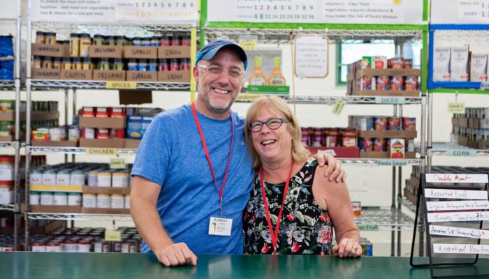 Two volunteers at a food pantry