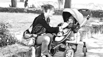 young parent stock photo with baby carriage