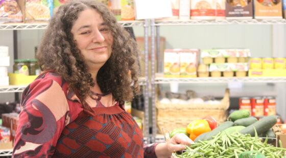 Volunteer with a selection of food at the Center for Self-Reliance